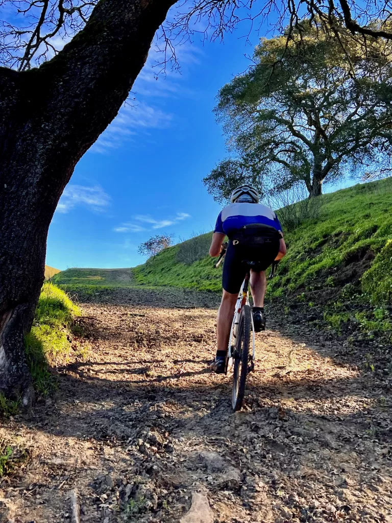 gravel cyclist on a steep climb